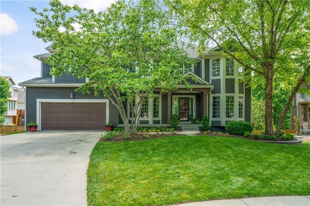 13897 W 140th St, Olathe, KS 66062 - view of front of home featuring stucco siding, concrete driveway, a front lawn, and a garage