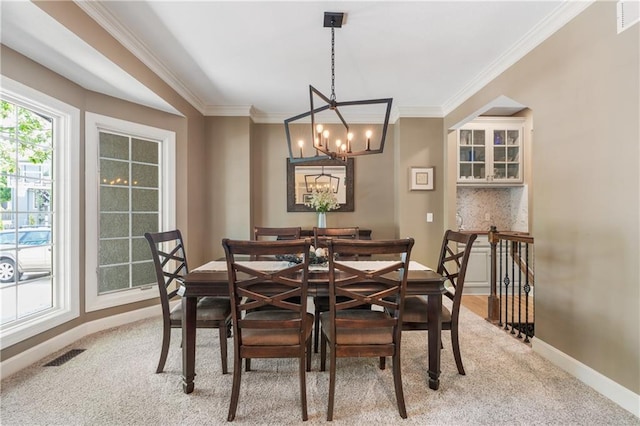 13897 W 140th St, Olathe, KS 66062 - dining area with light colored carpet, ornamental molding, baseboards, and a chandelier