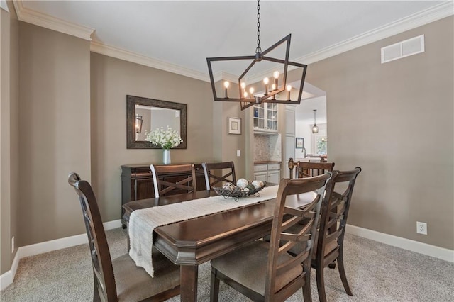 13897 W 140th St, Olathe, KS 66062 - dining area featuring light colored carpet, ornamental molding, a chandelier, and baseboards