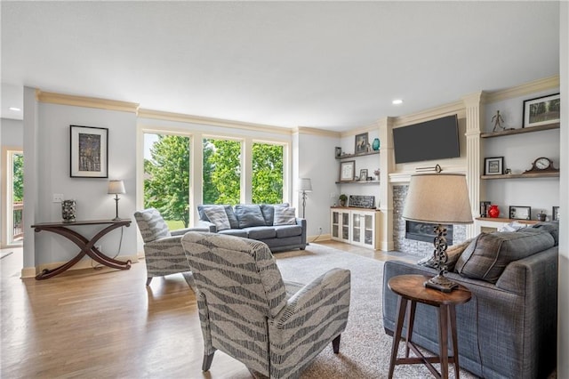 13897 W 140th St, Olathe, KS 66062 - living room featuring ornamental molding, baseboards, wood finished floors, recessed lighting, and a glass covered fireplace