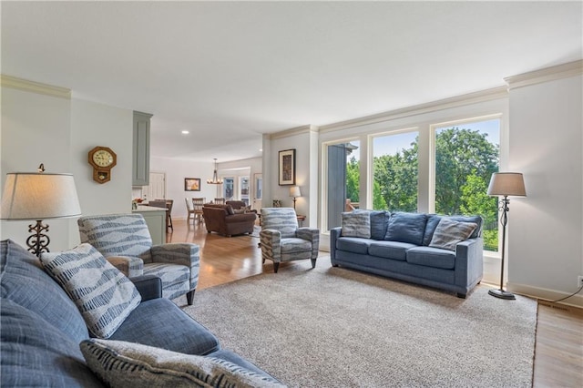 13897 W 140th St, Olathe, KS 66062 - living area with light wood-style flooring, crown molding, baseboards, and a chandelier