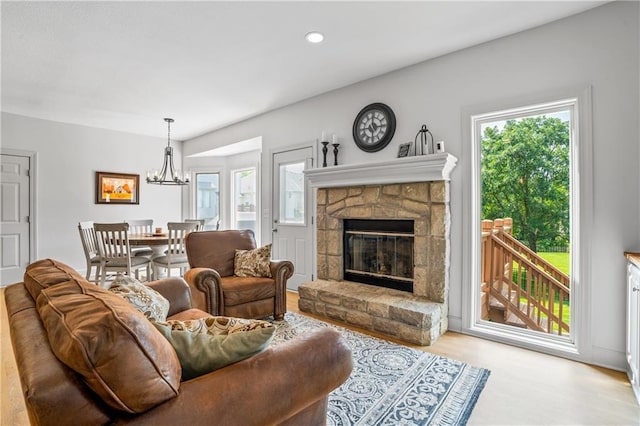 13897 W 140th St, Olathe, KS 66062 - living area featuring a chandelier, light wood finished floors, a stone fireplace, and recessed lighting