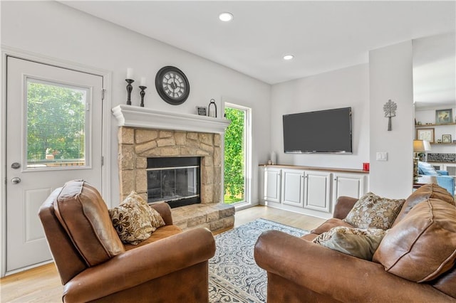 13897 W 140th St, Olathe, KS 66062 - living room with light wood-style flooring, a stone fireplace, and recessed lighting