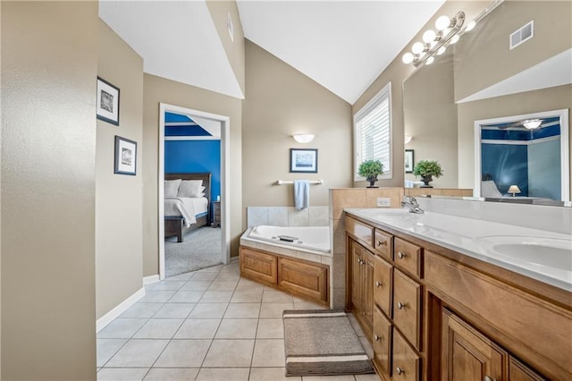 13897 W 140th St, Olathe, KS 66062 - bathroom with ensuite bath, double vanity, vaulted ceiling, a bath, and tile patterned floors