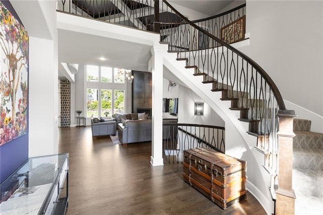 5947 N Cosby St, Kansas City, MO 64151 - staircase with a high ceiling, wood finished floors, and baseboards