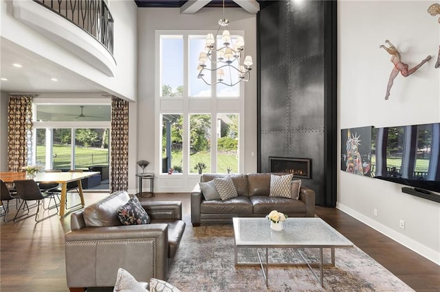 5947 N Cosby St, Kansas City, MO 64151 - living room with a high ceiling, a large fireplace, a chandelier, baseboards, and recessed lighting