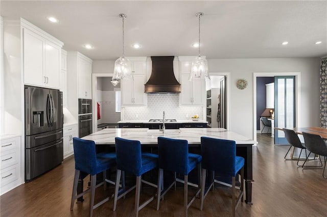 5947 N Cosby St, Kansas City, MO 64151 - kitchen with stainless steel refrigerator with ice dispenser, premium range hood, dark wood-type flooring, oven, and tasteful backsplash