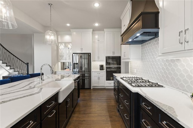 5947 N Cosby St, Kansas City, MO 64151 - kitchen featuring custom exhaust hood, black appliances, a sink, white cabinetry, and recessed lighting
