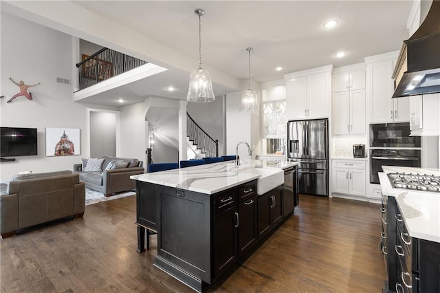 5947 N Cosby St, Kansas City, MO 64151 - kitchen featuring stainless steel appliances, a sink, wall chimney exhaust hood, open floor plan, and recessed lighting