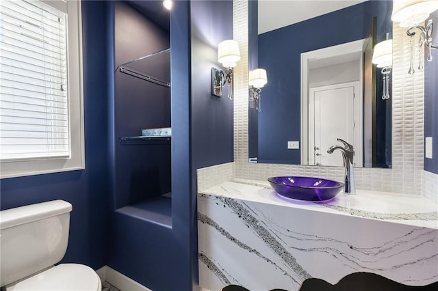 5947 N Cosby St, Kansas City, MO 64151 - bathroom with backsplash, toilet, and vanity