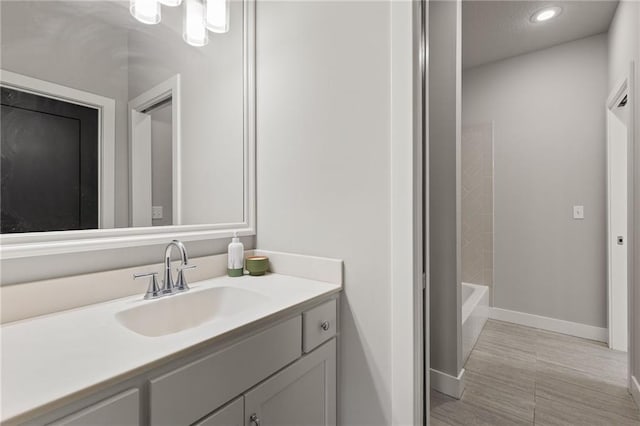 5947 N Cosby St, Kansas City, MO 64151 - bathroom featuring vanity, baseboards, and recessed lighting