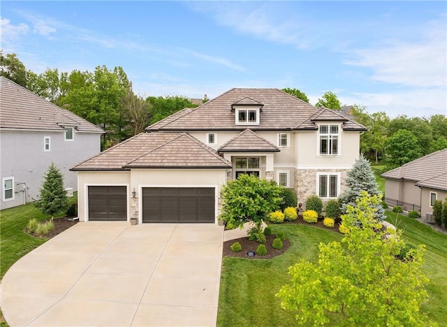 5947 N Cosby St, Kansas City, MO 64151 - french provincial home featuring stucco siding, concrete driveway, a front lawn, an attached garage, and stone siding