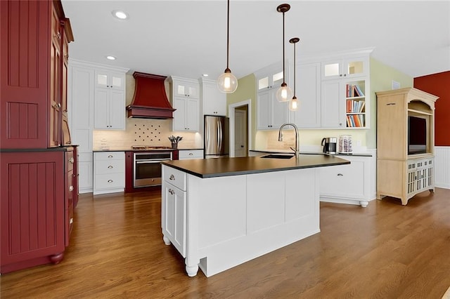 12712 W 126th St, Overland Park, KS 66213 - kitchen with stainless steel appliances, premium range hood, dark countertops, dark wood-style floors, and decorative backsplash