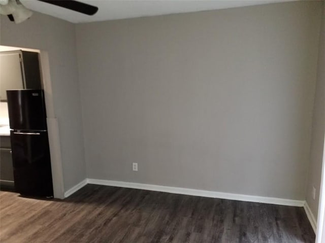 8828 N Main St, Kansas City, MO 64155 - empty room featuring a ceiling fan, dark wood-type flooring, and baseboards