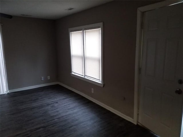 8828 N Main St, Kansas City, MO 64155 - empty room featuring baseboards and dark wood-style floors