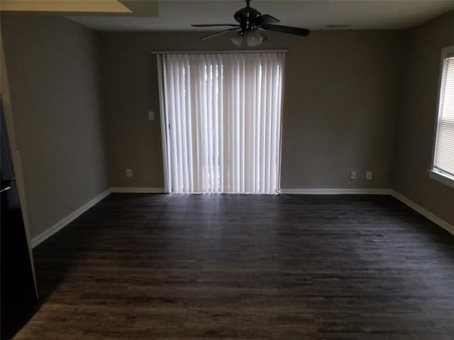8828 N Main St, Kansas City, MO 64155 - unfurnished room with plenty of natural light, a ceiling fan, and dark wood finished floors