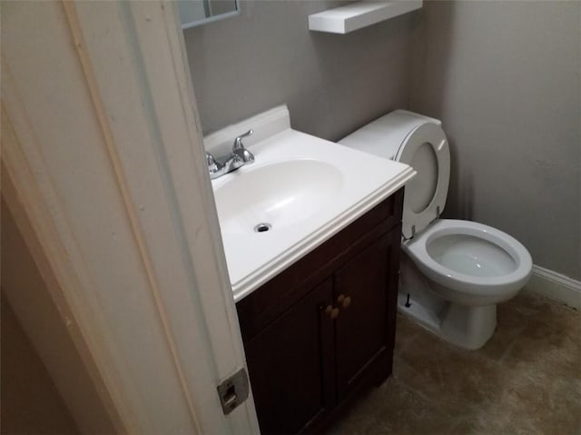 8828 N Main St, Kansas City, MO 64155 - half bathroom featuring vanity, toilet, and baseboards