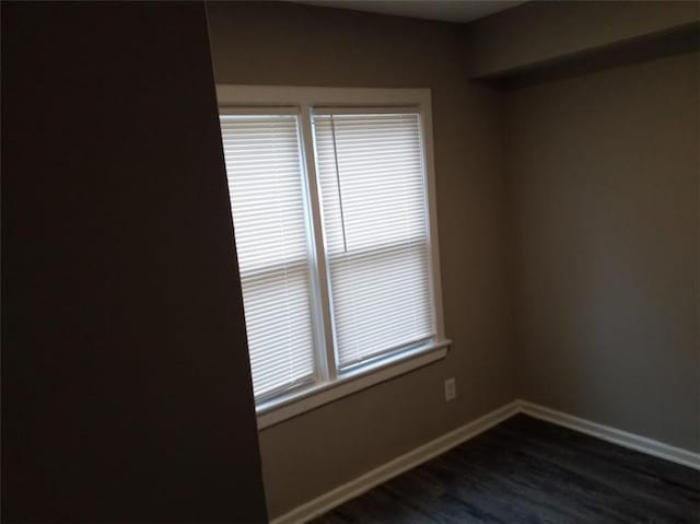 8828 N Main St, Kansas City, MO 64155 - spare room featuring dark wood-style flooring and baseboards