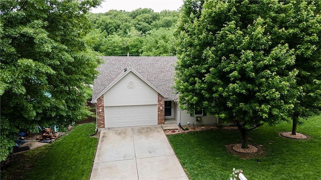 1604 S 105th Ter, Edwardsville, KS 66111 - view of front of property featuring driveway, a garage, a front yard, roof with shingles, and brick siding