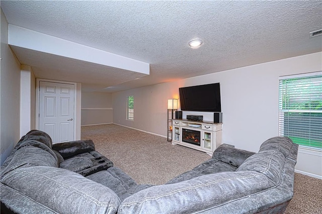 1604 S 105th Ter, Edwardsville, KS 66111 - carpeted living area with a textured ceiling and baseboards