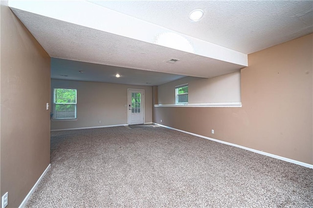 1604 S 105th Ter, Edwardsville, KS 66111 - carpeted spare room featuring a textured ceiling, baseboards, and healthy amount of natural light