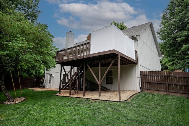 1604 S 105th Ter, Edwardsville, KS 66111 - rear view of property with stairway, a deck, a chimney, a shingled roof, and board and batten siding