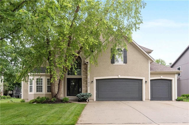 11412 S Lakecrest Dr, Olathe, KS 66061 - view of front of home with driveway, a front yard, stucco siding, a garage, and a shingled roof