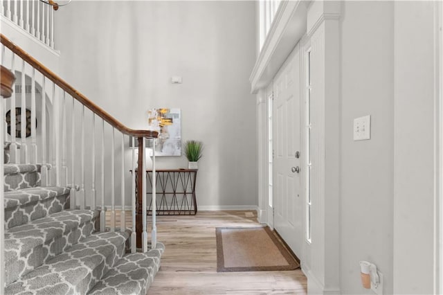 11412 S Lakecrest Dr, Olathe, KS 66061 - entrance foyer featuring a towering ceiling, stairs, wood finished floors, and baseboards