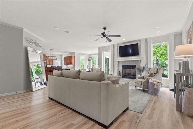 11412 S Lakecrest Dr, Olathe, KS 66061 - living area with light wood finished floors, ceiling fan, a glass covered fireplace, recessed lighting, and baseboards