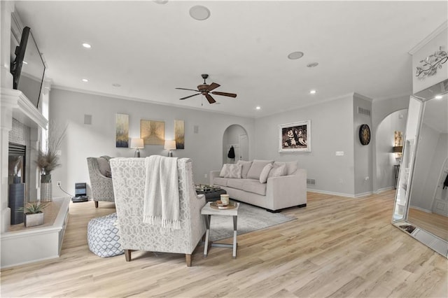 11412 S Lakecrest Dr, Olathe, KS 66061 - living room with arched walkways, ornamental molding, a ceiling fan, light wood-style floors, and recessed lighting
