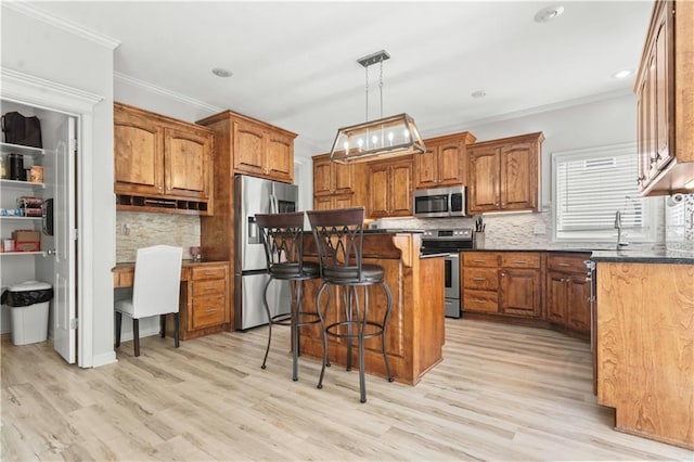 11412 S Lakecrest Dr, Olathe, KS 66061 - kitchen with stainless steel appliances, brown cabinetry, crown molding, a kitchen breakfast bar, and tasteful backsplash