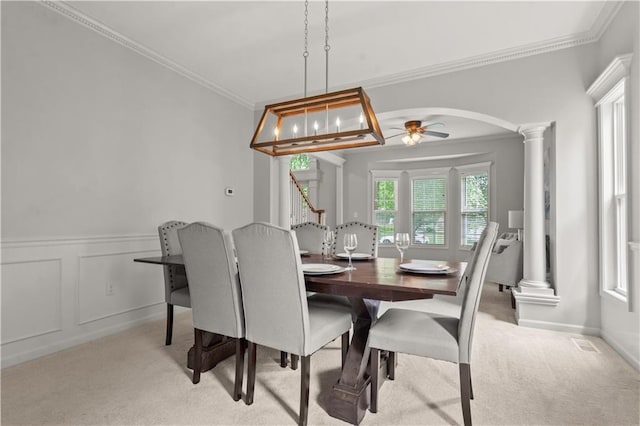 11412 S Lakecrest Dr, Olathe, KS 66061 - dining space with decorative columns, carpet flooring, ornamental molding, arched walkways, and a wainscoted wall