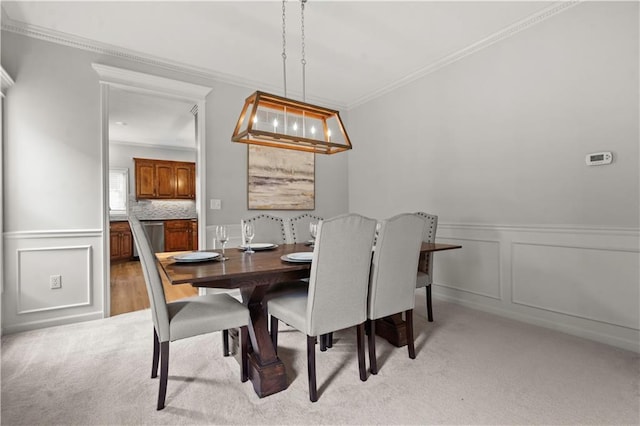 11412 S Lakecrest Dr, Olathe, KS 66061 - dining space featuring ornamental molding, light colored carpet, a decorative wall, and a wainscoted wall