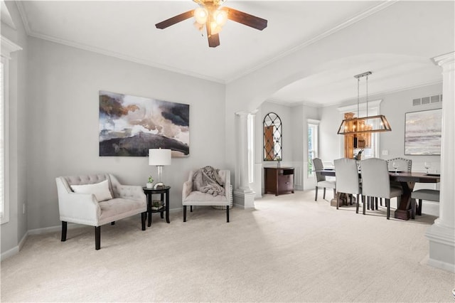 11412 S Lakecrest Dr, Olathe, KS 66061 - sitting room featuring ornate columns, arched walkways, ceiling fan, carpet floors, and crown molding