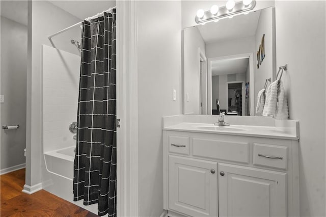 11412 S Lakecrest Dr, Olathe, KS 66061 - bathroom featuring vanity, shower / tub combo, wood finished floors, and baseboards