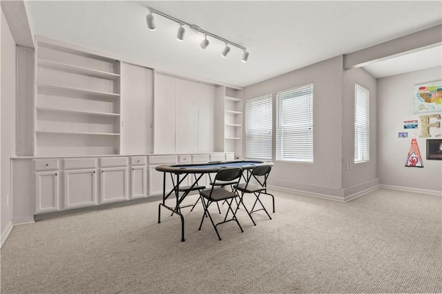 11412 S Lakecrest Dr, Olathe, KS 66061 - dining area featuring light carpet, track lighting, baseboards, and built in features
