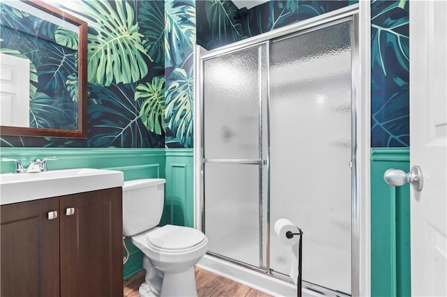 11412 S Lakecrest Dr, Olathe, KS 66061 - full bathroom featuring vanity, wood finished floors, a stall shower, toilet, and wallpapered walls