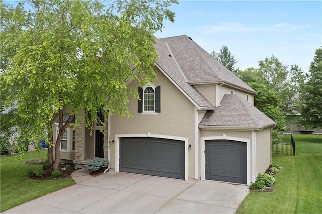 11412 S Lakecrest Dr, Olathe, KS 66061 - view of front of home featuring stucco siding, a shingled roof, driveway, and a garage