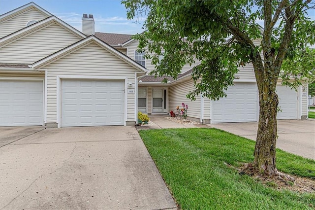 1413 SE Norwood Dr, Lees Summit, MO 64081 - view of front of home with driveway, a chimney, a front lawn, and a garage