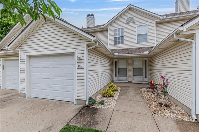 1413 SE Norwood Dr, Lees Summit, MO 64081 - doorway to property with a chimney, an attached garage, concrete driveway, and a shingled roof