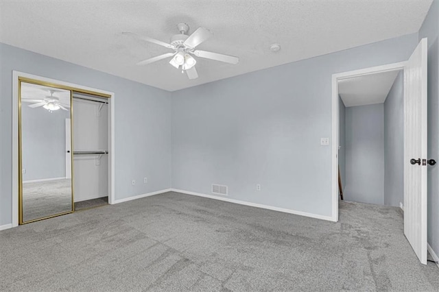 1413 SE Norwood Dr, Lees Summit, MO 64081 - unfurnished bedroom featuring carpet floors, a textured ceiling, a ceiling fan, a closet, and baseboards