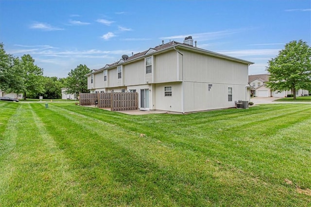 1413 SE Norwood Dr, Lees Summit, MO 64081 - rear view of house featuring a lawn and central AC