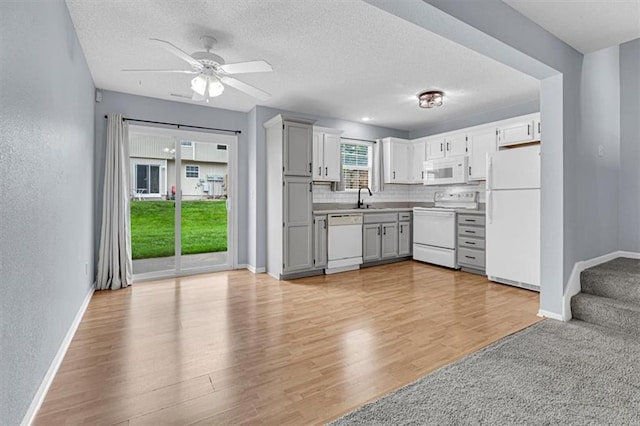 1413 SE Norwood Dr, Lees Summit, MO 64081 - kitchen featuring white appliances, a sink, baseboards, a ceiling fan, and a textured wall