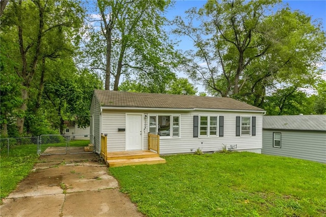 704 W 38th St N, Independence, MO 64052 - view of front facade with a gate, driveway, and a shingled roof