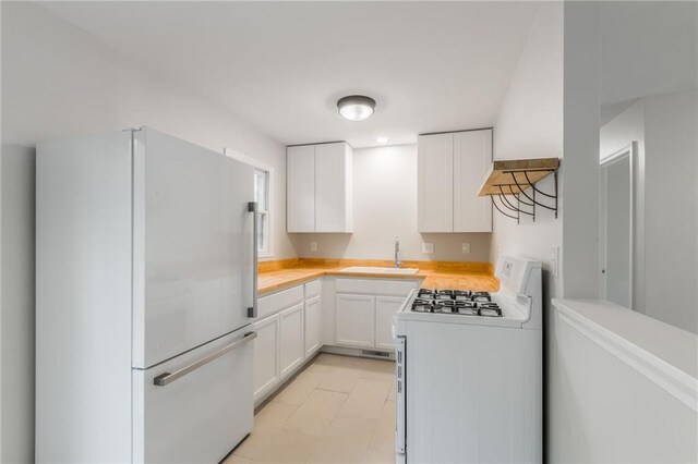 704 W 38th St N, Independence, MO 64052 - kitchen with white appliances, a sink, light countertops, and white cabinetry