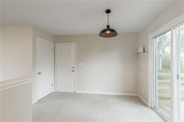 704 W 38th St N, Independence, MO 64052 - unfurnished dining area with baseboards and light tile patterned floors