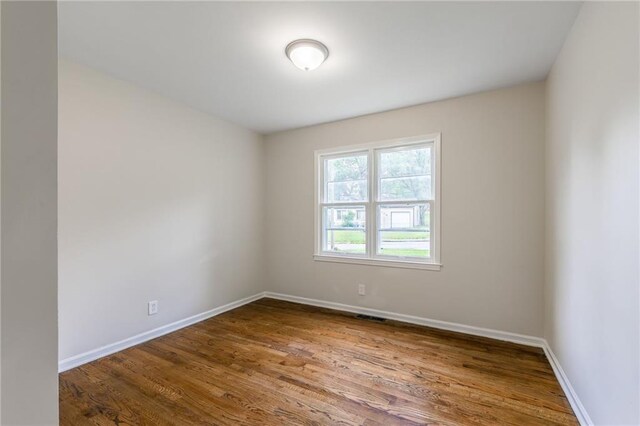704 W 38th St N, Independence, MO 64052 - unfurnished room with wood finished floors and baseboards