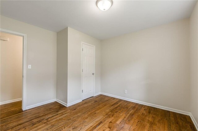 704 W 38th St N, Independence, MO 64052 - unfurnished bedroom featuring baseboards, wood finished floors, and a closet