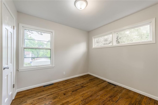704 W 38th St N, Independence, MO 64052 - unfurnished room featuring baseboards and dark wood-type flooring