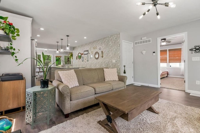 920 S Washington St, Independence, MO 64050 - living room with wood finished floors, plenty of natural light, baseboards, recessed lighting, and ceiling fan